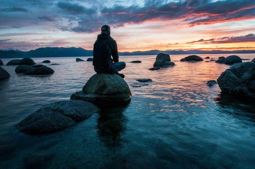 A man meditating in the ocean pondering "what is meditation"?